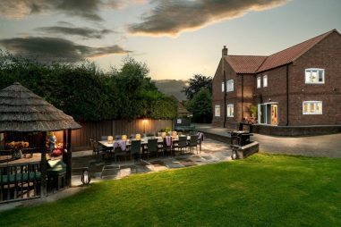 Patio at sunset with seating for up to 16 and a BBQ