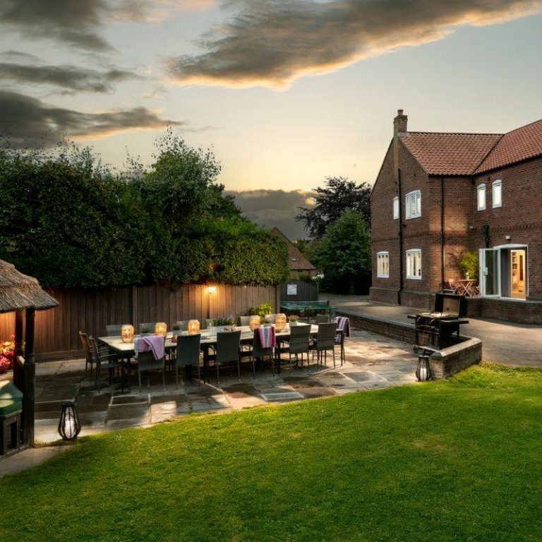 Patio at sunset with seating for up to 16 and a BBQ
